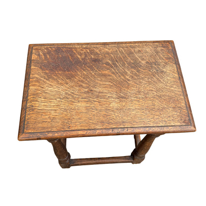 Small oak joint stool side table with pegged plank top and turned legs