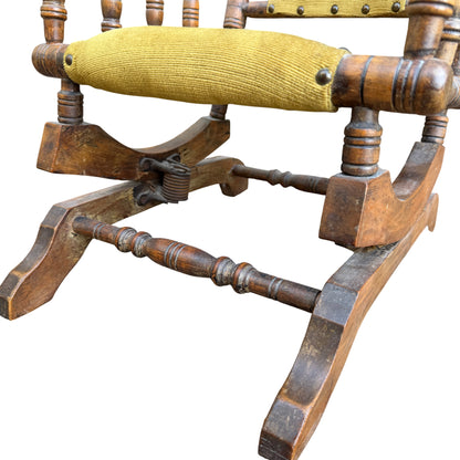 Close-up of sprung rocker hardware and wooden rockers on child's chair