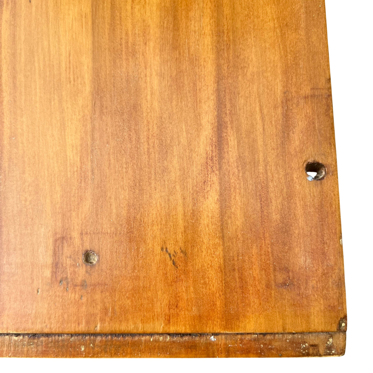 Close-up of round metal drawer knob and surrounding fixings