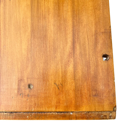 Close-up of round metal drawer knob and surrounding fixings