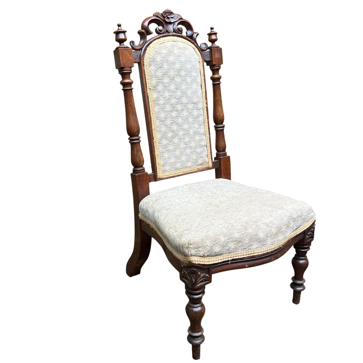 Carved scrollwork and leaf detail to the chair's top rail