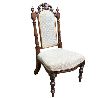 Carved scrollwork and leaf detail to the chair's top rail