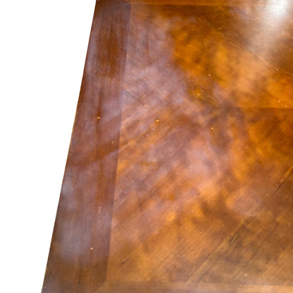 Close-up view of coffee table edge showing veneer finish and small edge chips