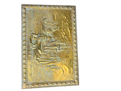 Rear corner of vintage brass storage box with hammered metal surface