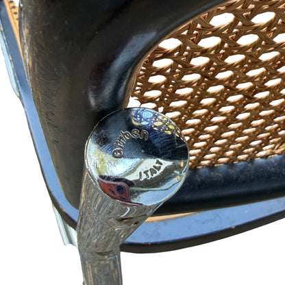 Woven cane backrest detail showing join to black timber surround on an Italian cantilever chair