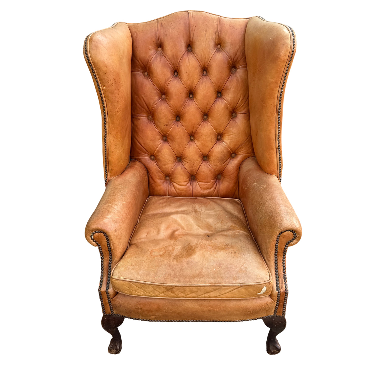 Top view of removable tan leather seat cushion with visible staining and wear