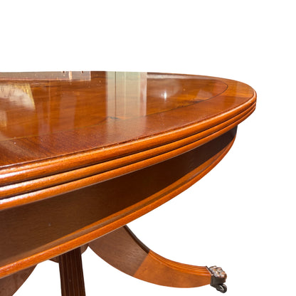 Carved paw style foot with castor under a vintage mahogany‑tone dining table
