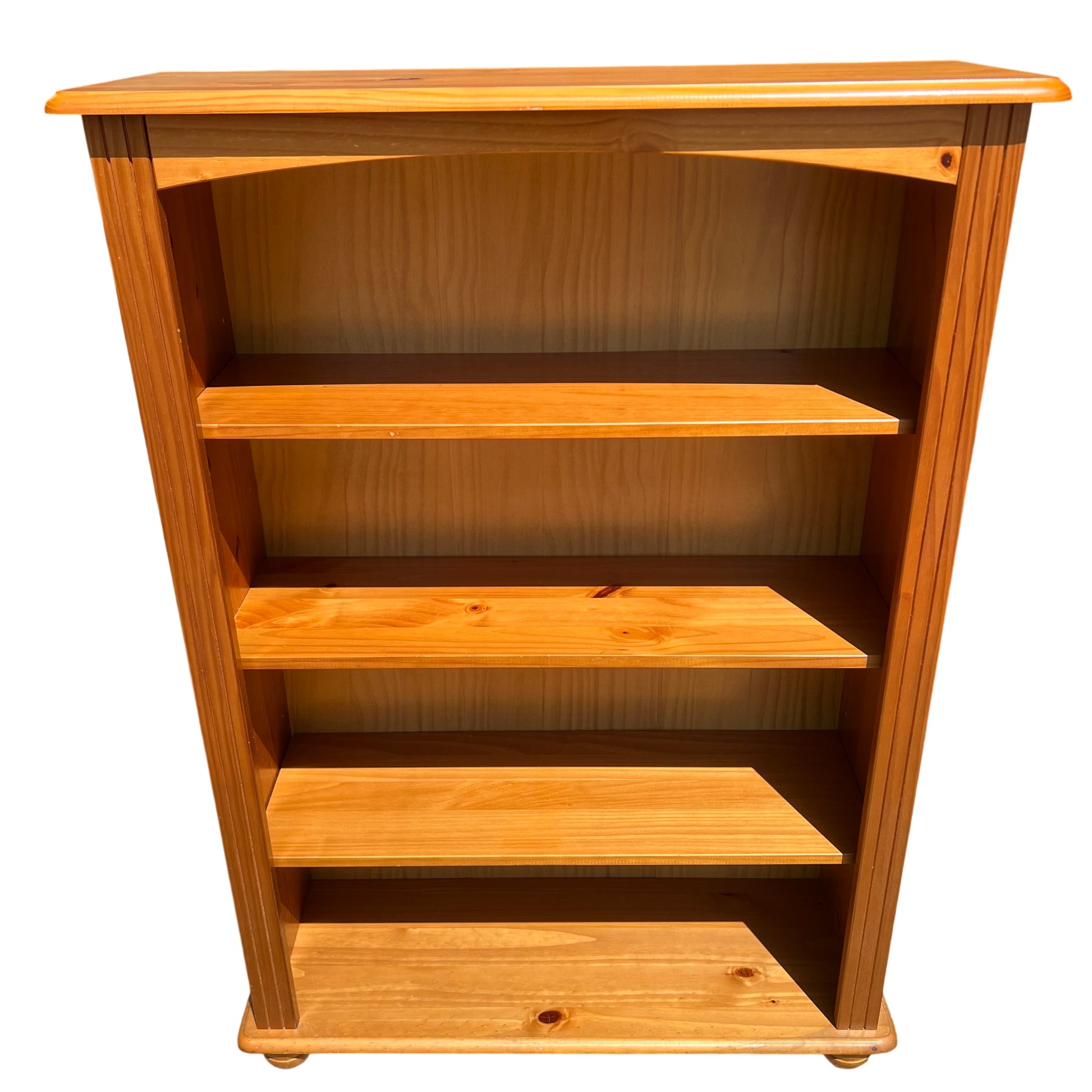Front view pine bookcase with four internal shelves and moulded top
