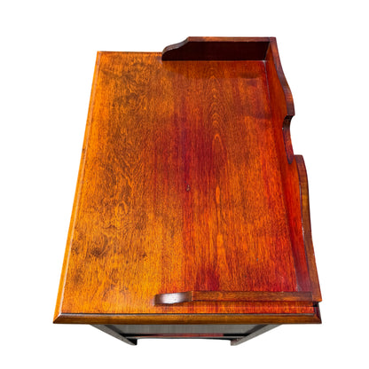 Front view of multiple shallow drawers with circular ring pulls on music cabinet