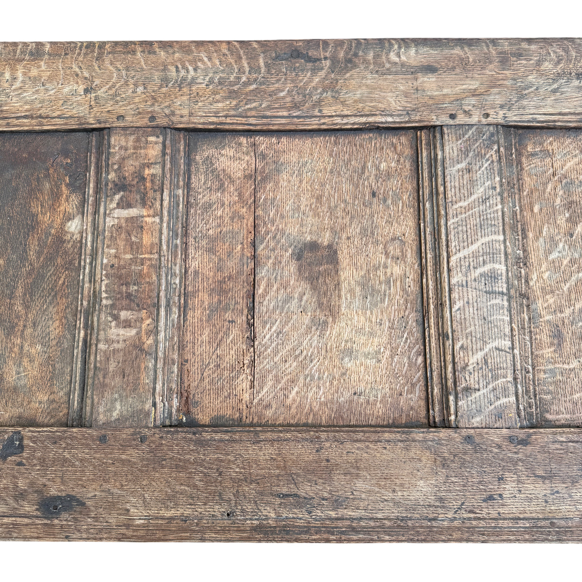 Top edge of oak coffer lid showing wear, small repairs and aged patina