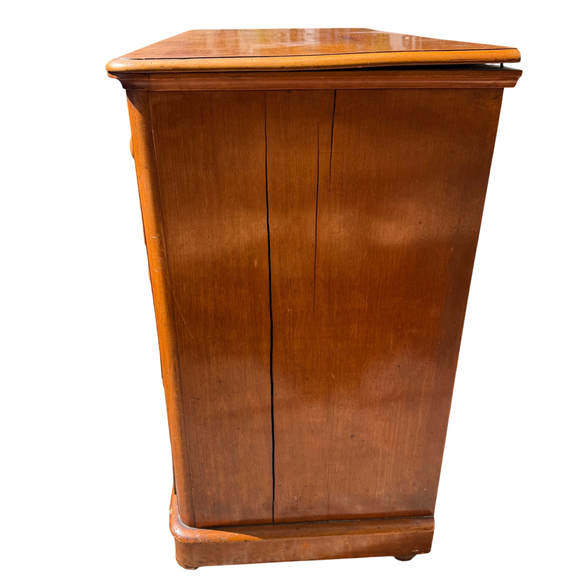 Profile view of turned wooden knobs and drawer fronts on pine chest