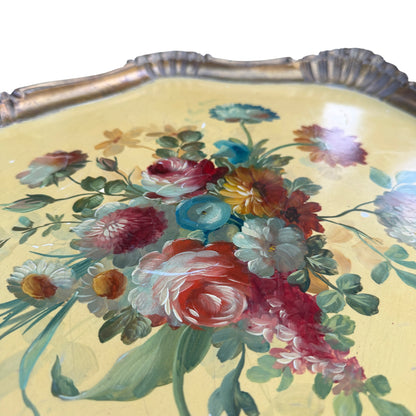 Close-up of hand-painted floral bouquet on yellow background of vintage tray