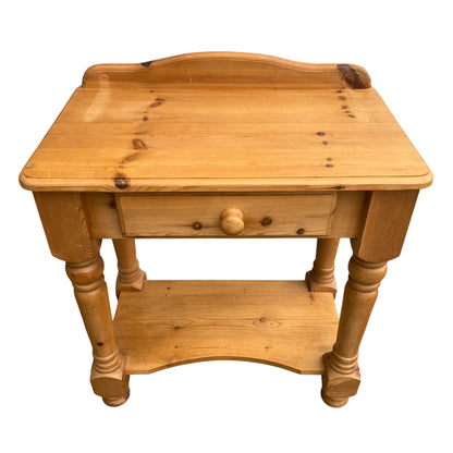Top view of pine hall table showing shaped backboard and moulded edge