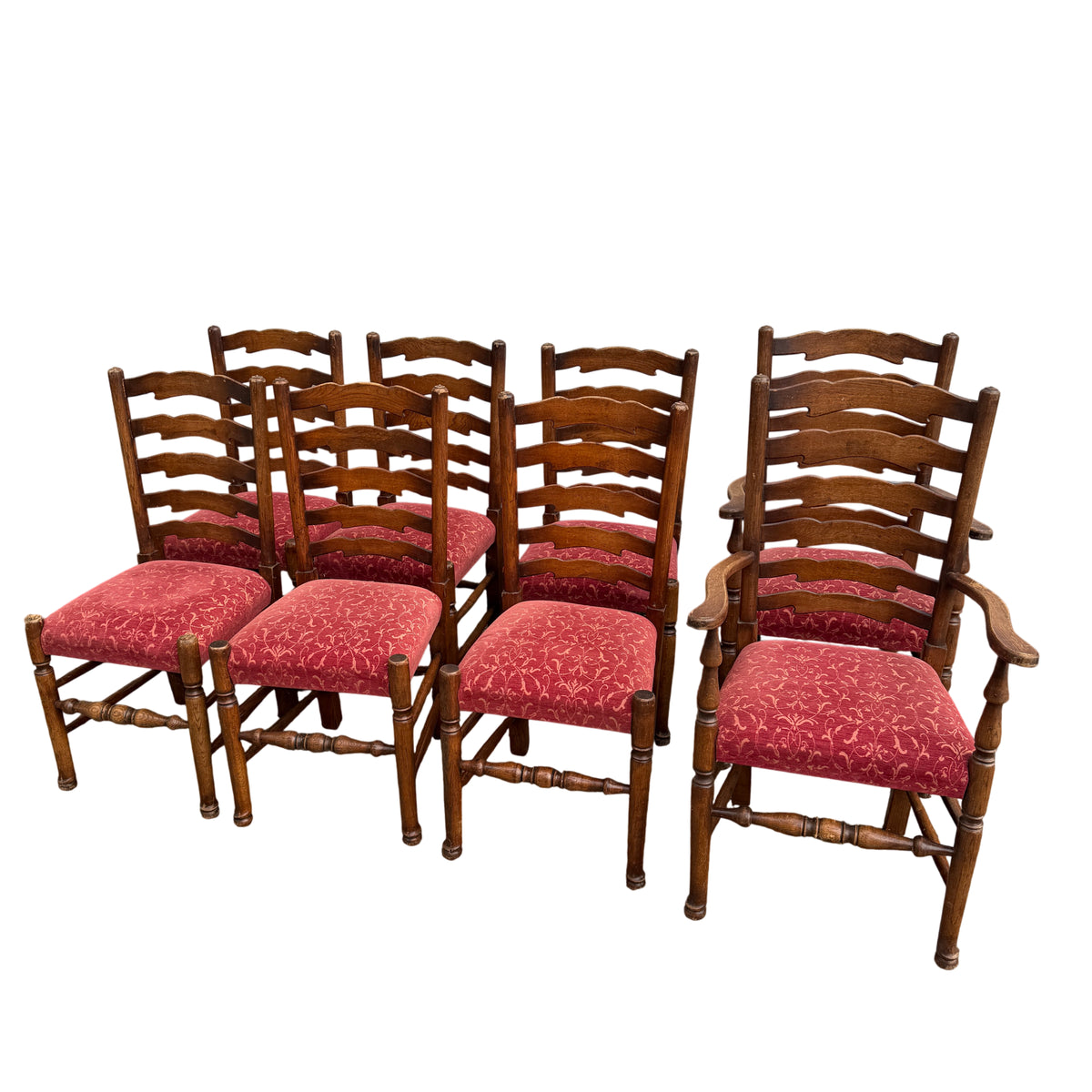 Close view of oak ladderback dining chairs with turned legs and red patterned seats