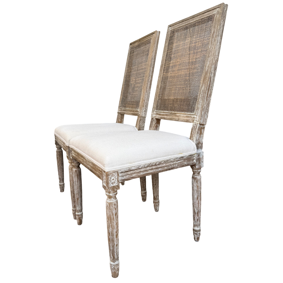 Carved floral corner detail on the frame of a French-style dining chair