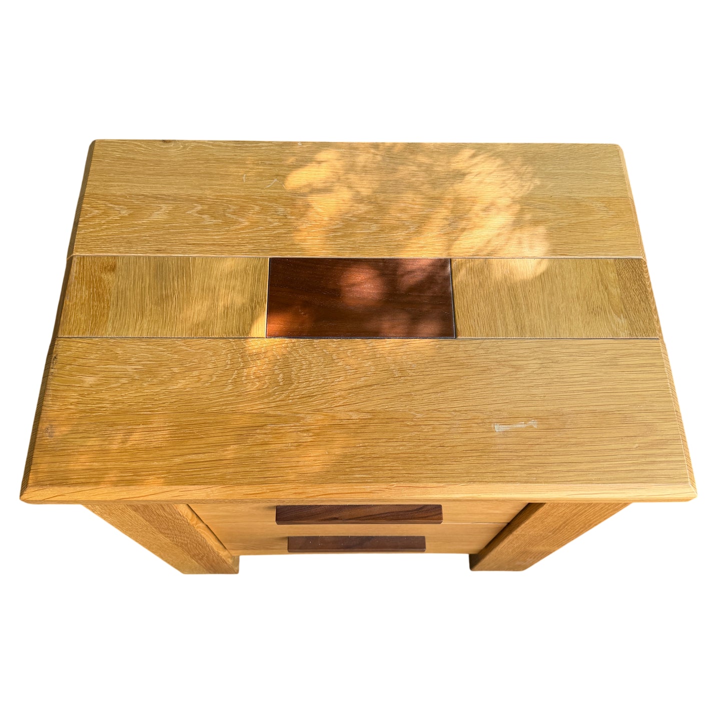 Top view of oak bedside cabinets showing inset darker panels and surface wear