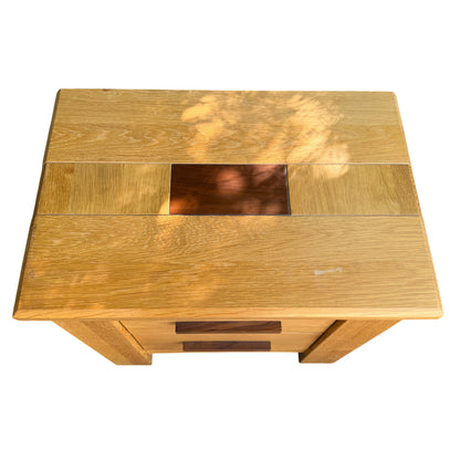 Top view of oak bedside cabinets showing inset darker panels and surface wear