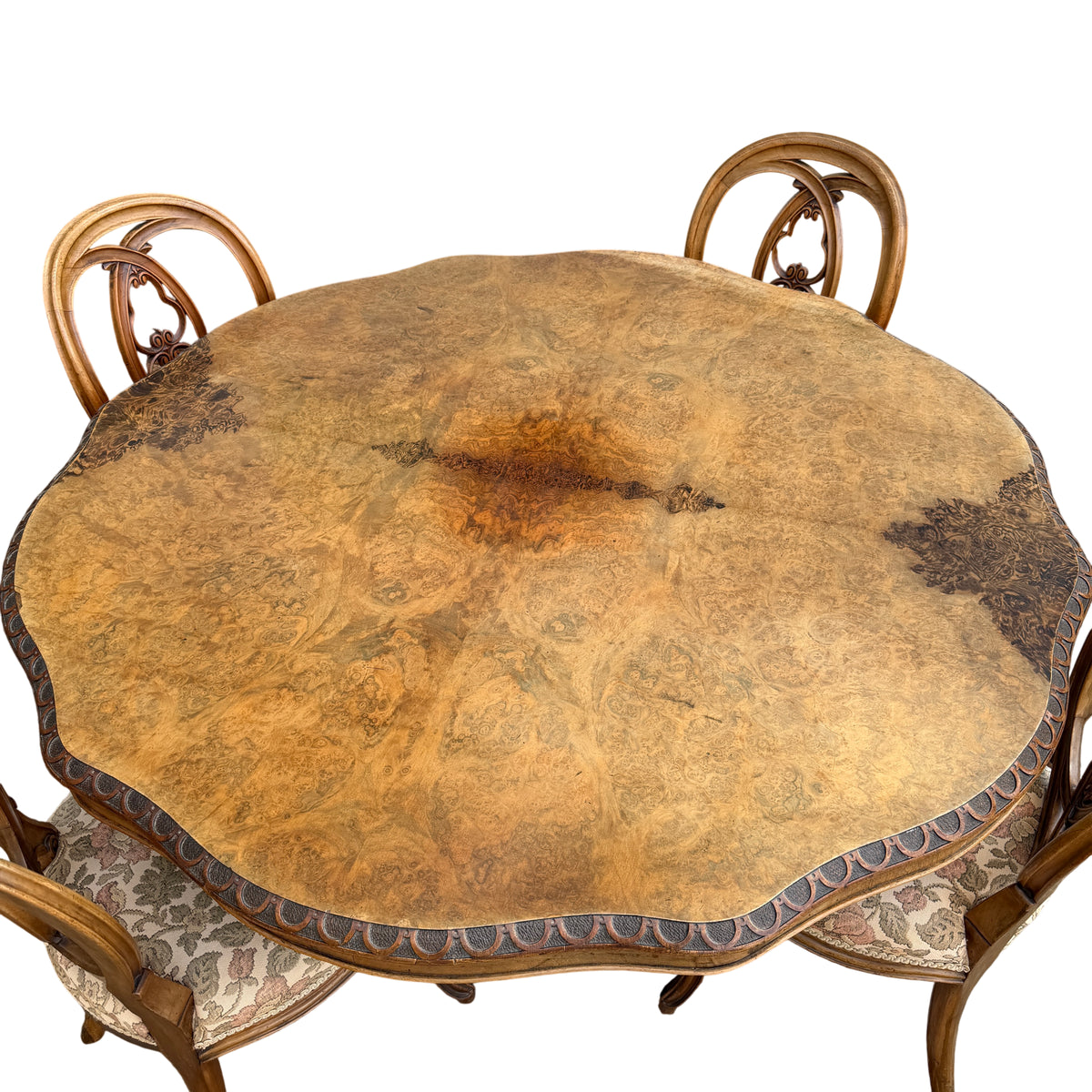 Carved pedestal base of dining table fitted with contemporary castor wheels