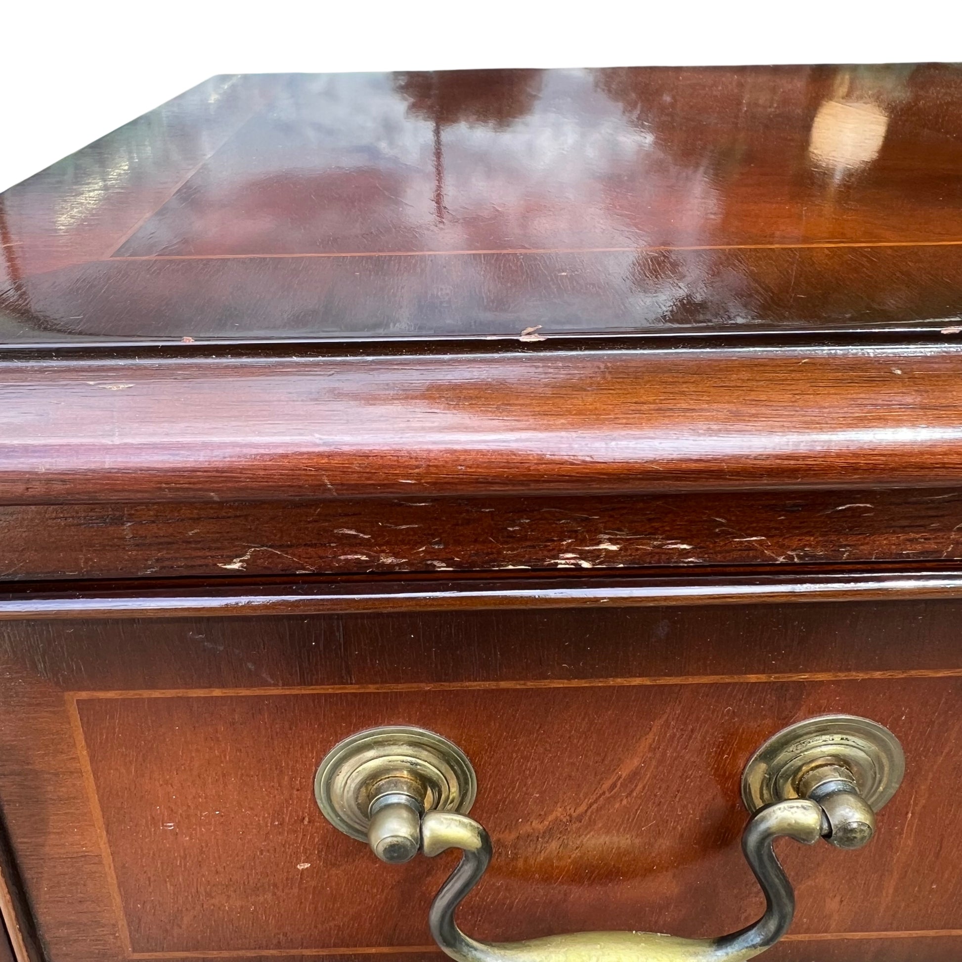 Stacked drawer fronts with inlaid veneer pattern on mahogany chest