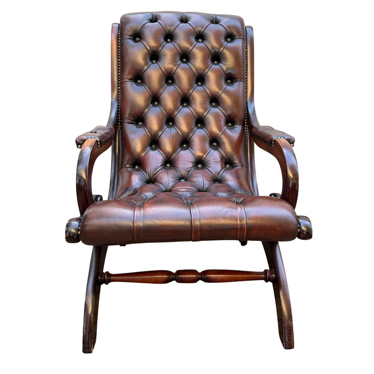 Front view button-tufted brown leather armchair with wooden arms and studded detail