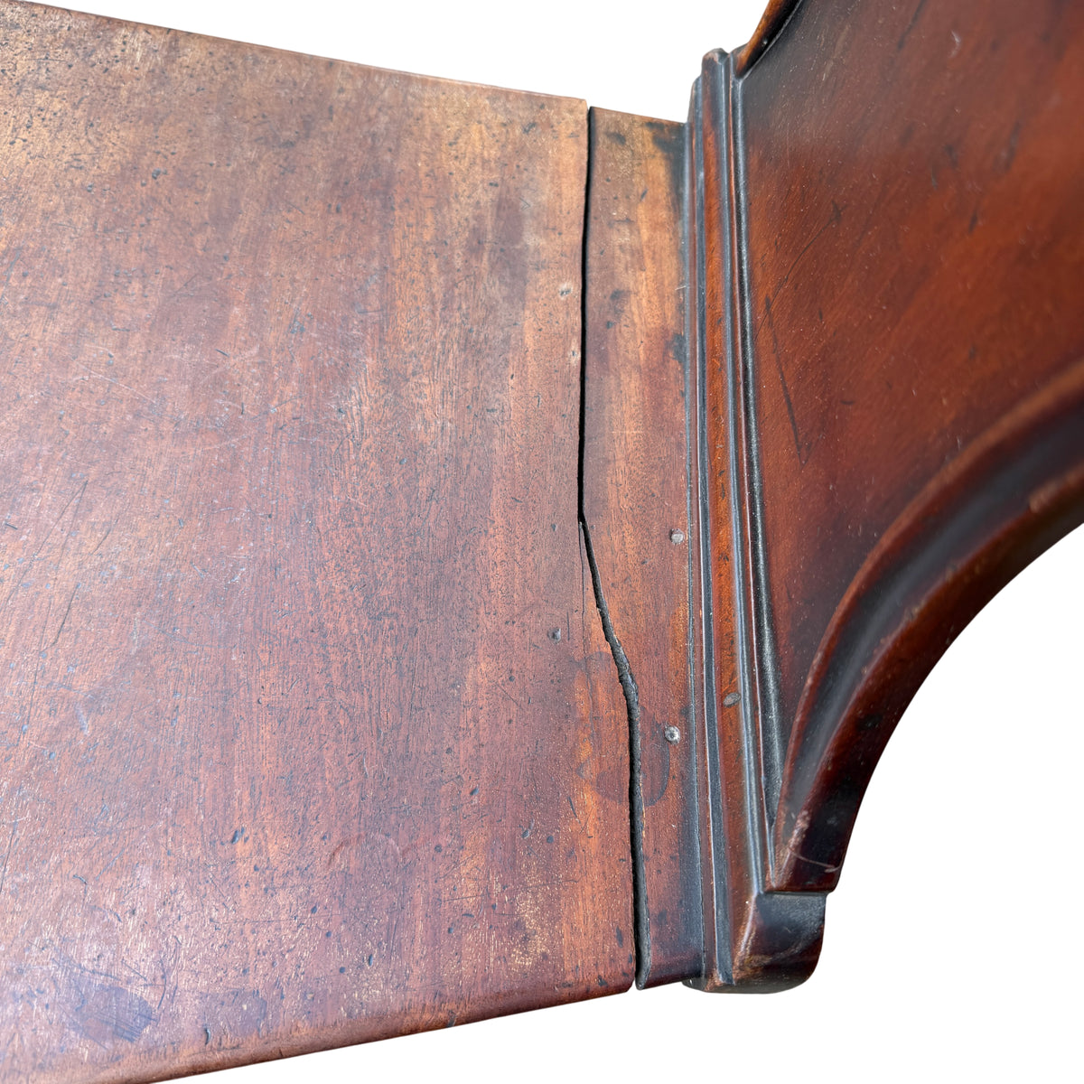 Solid wooden seat and scuffed finish on Victorian mahogany chair