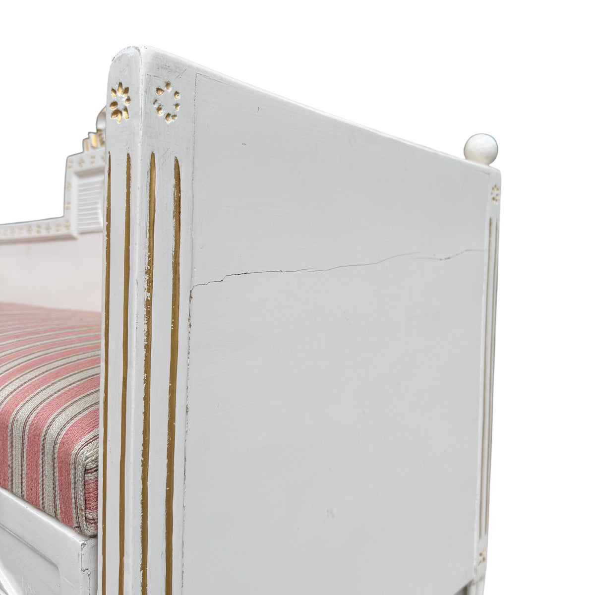 Side view of painted daybed showing turned tapering legs and paint loss