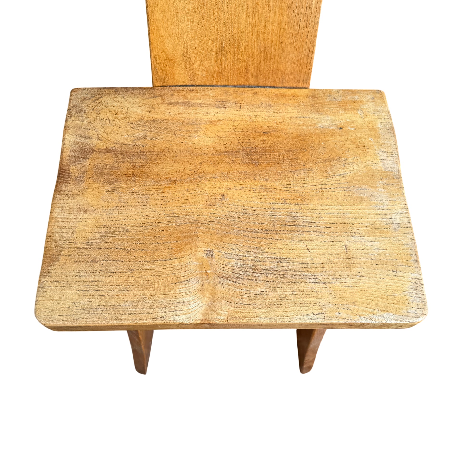 Four wooden kitchen chairs in oak finish arranged outdoors