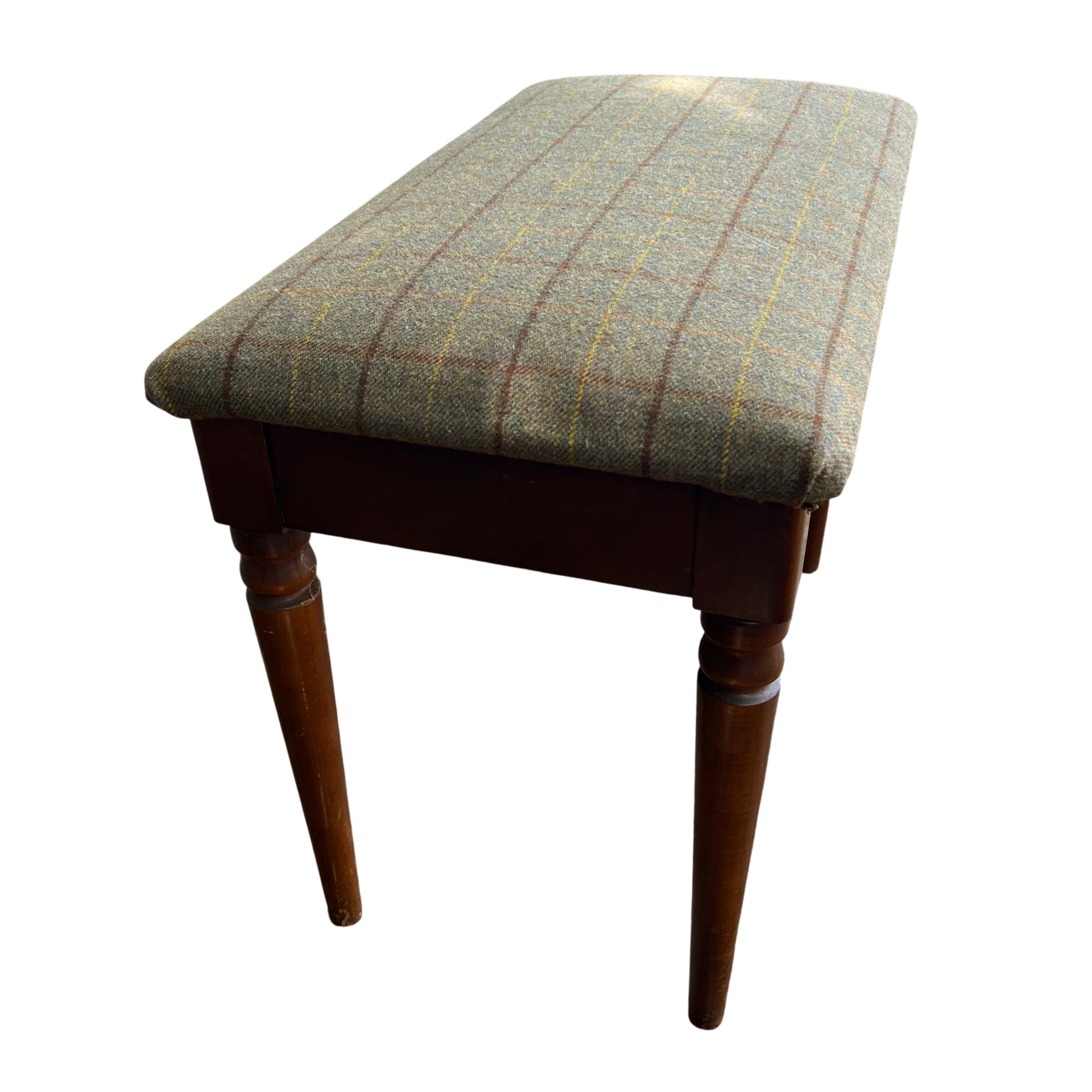 Side view of vintage tweed bench showing padded seat and wooden apron