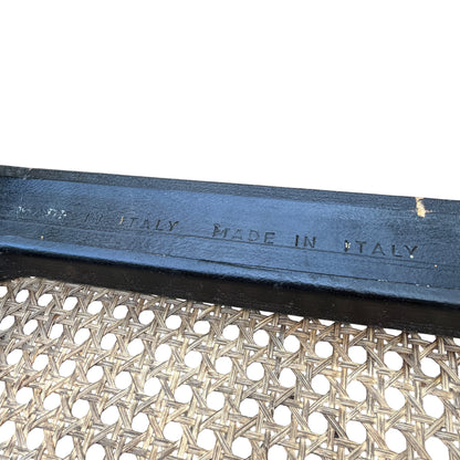 Close-up of cane weaving and timber edging showing wear and areas of finish loss on the surround