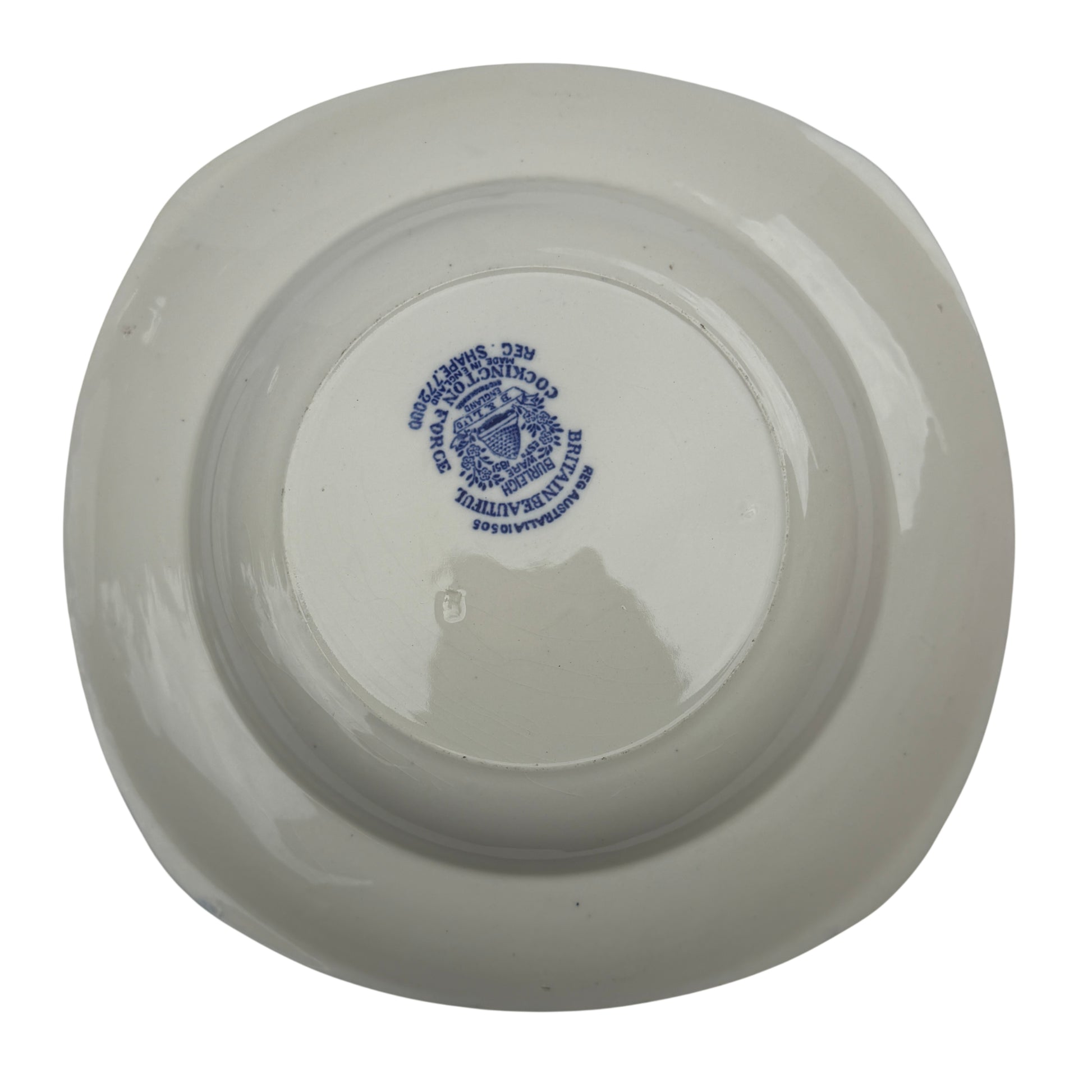 Overhead view of three matching Burleigh Ware blue and white bowls on studio backdrop