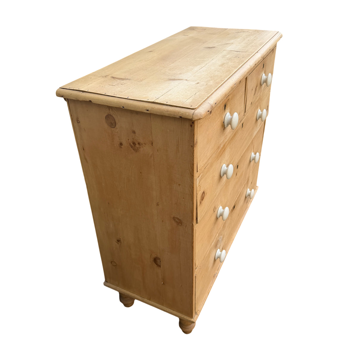 Front view of pine chest showing drawer layout and white ceramic knobs