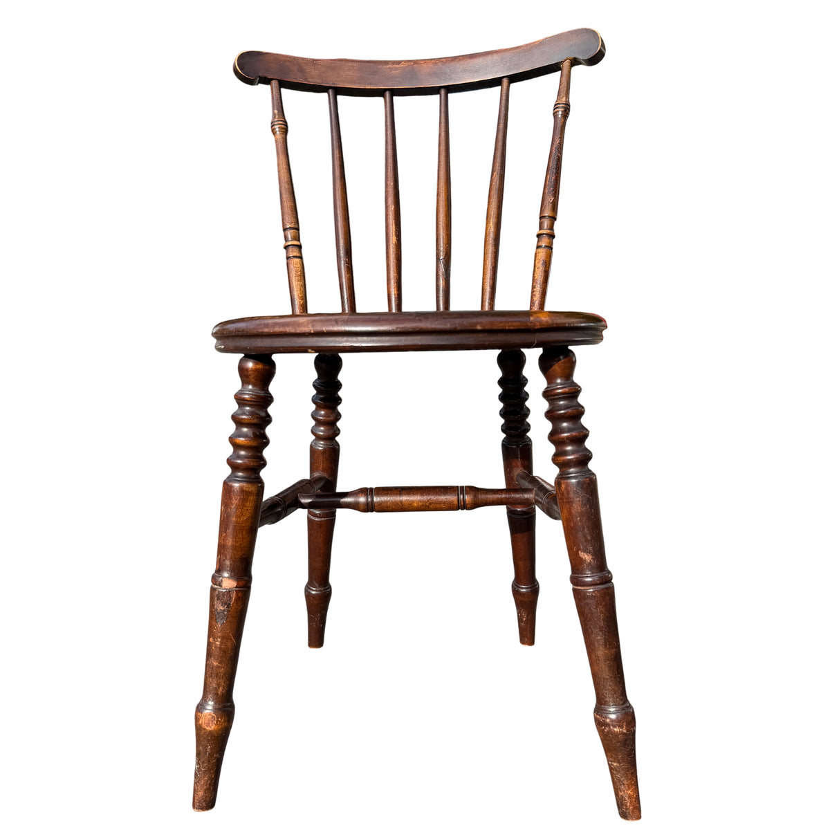 Detail of turned stretchers and legs on a vintage stickback dining chair