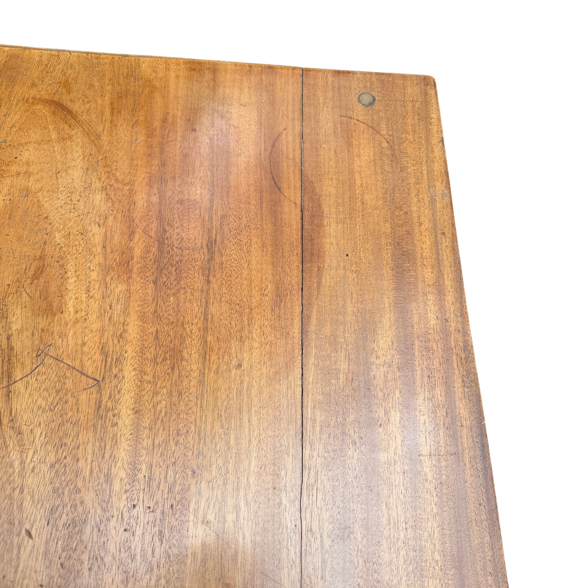Close-up of solid wood tabletop showing grain and ring marks on a vintage dressing table