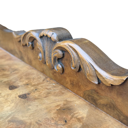 Close-up of metal drop handles and escutcheon on central drawers