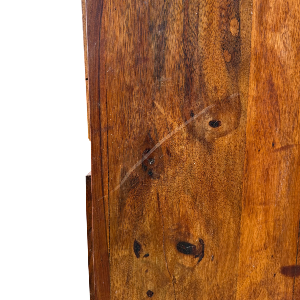 Detail of black iron ring handle on a recessed-panel drawer of wood chest