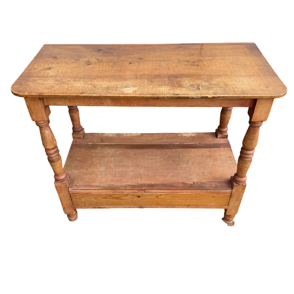 Top view of vintage pine hall table showing plank top with scratches and worn finish