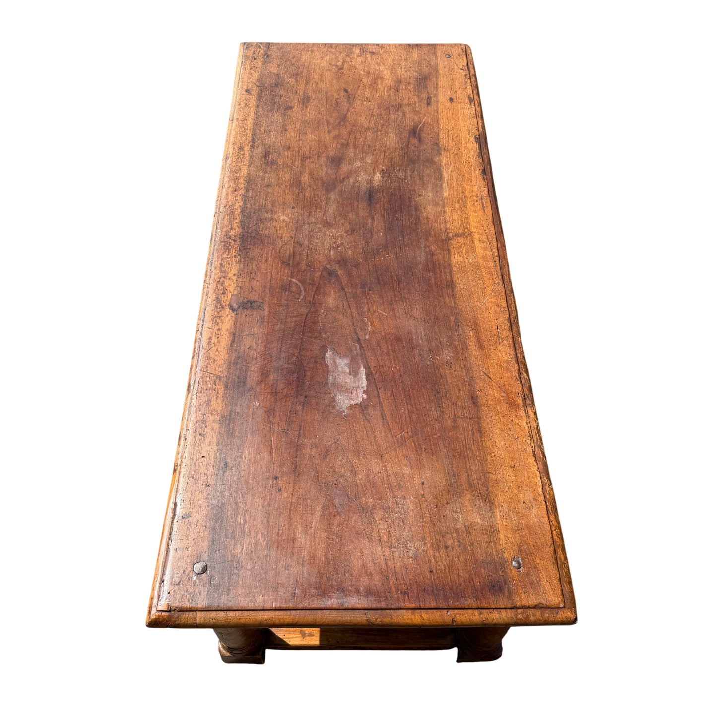 Close-up of oak coffee table top showing worn patina and surface marks