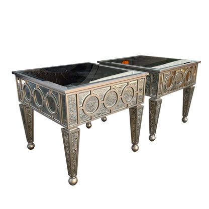 Pair of mirrored occasional tables placed outdoors showing full profile