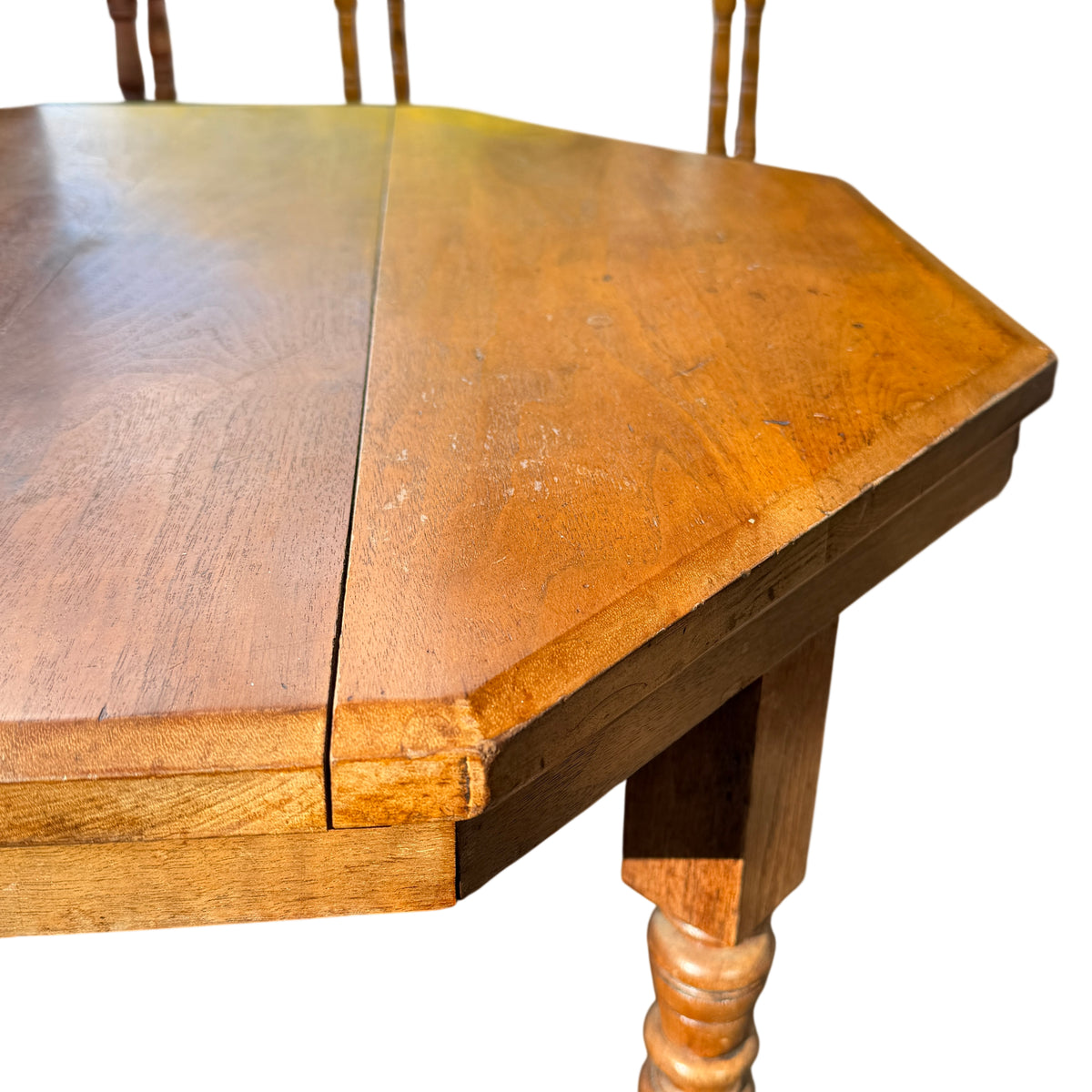 Side view showing apron and turned leg join on oak occasional table
