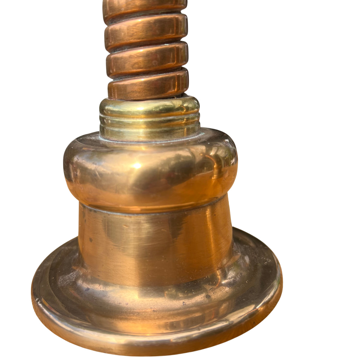 Two brass candle holders displayed on a wooden table, matching spiral design