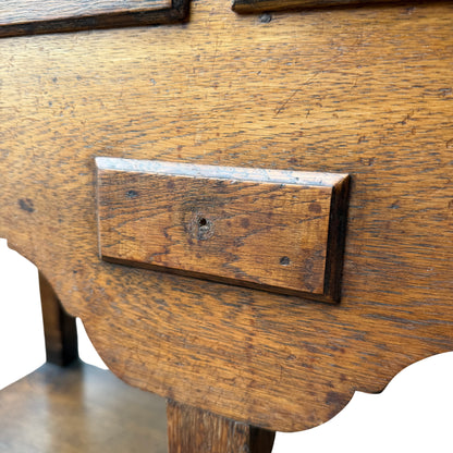 Three small faux drawer fronts across frieze of oak Welsh dresser, one handle missing
