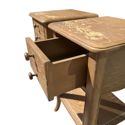 Pair of small bedside cabinets displayed outdoors on concrete surface