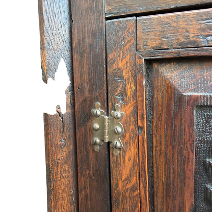 Edge wear and finish loss visible to top rail of oak corner cabinet