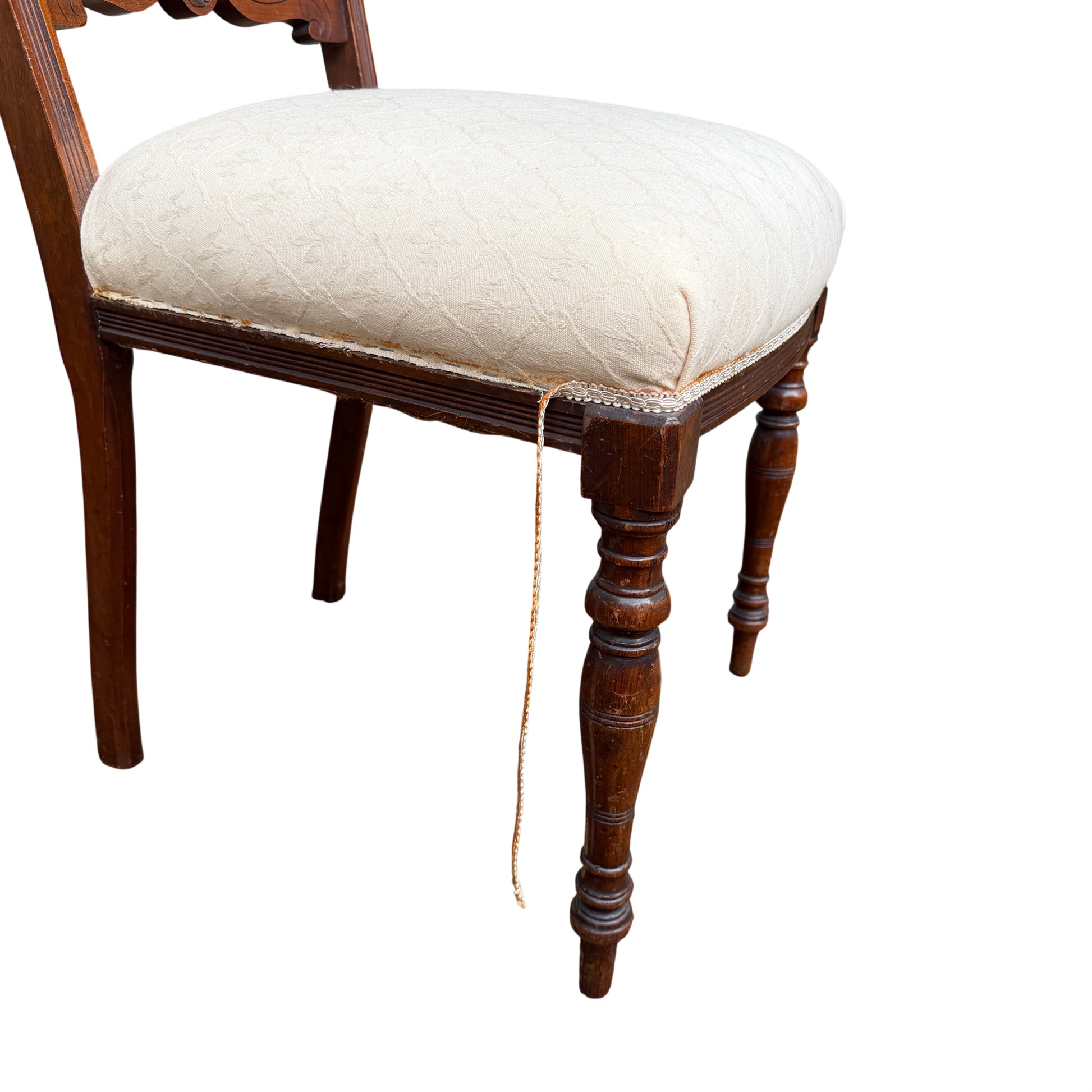 Side view of Edwardian upholstered dining chair showing carved back and seat profile