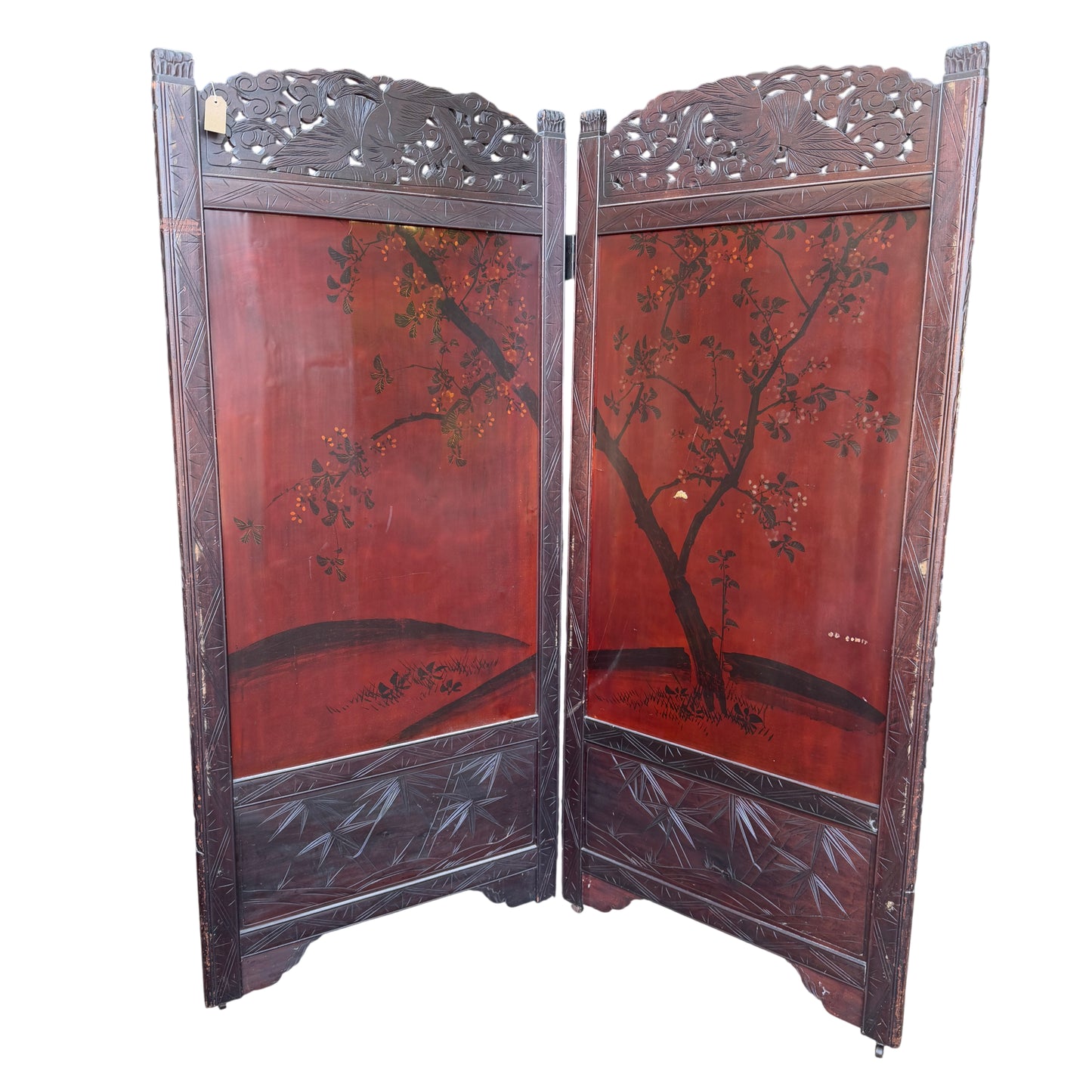 Worn lacquer surface detail on black panel of two-panel folding screen