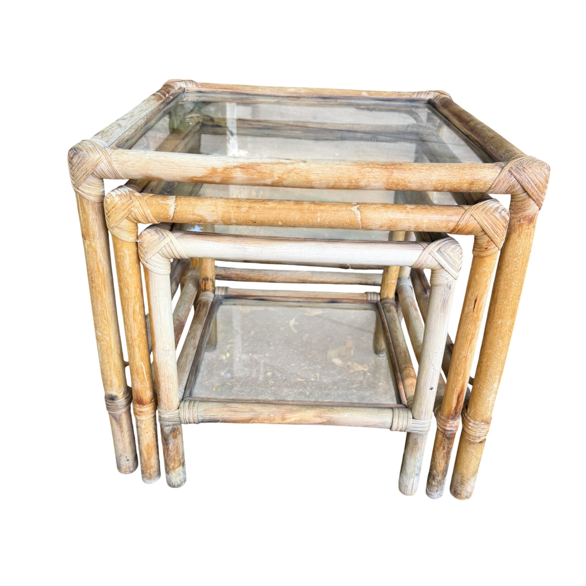 Detail of rattan frame and glass edge on a vintage nesting table