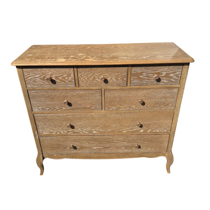 Angled view of painted oak chest showing cabriole-style legs and bead detail around drawers