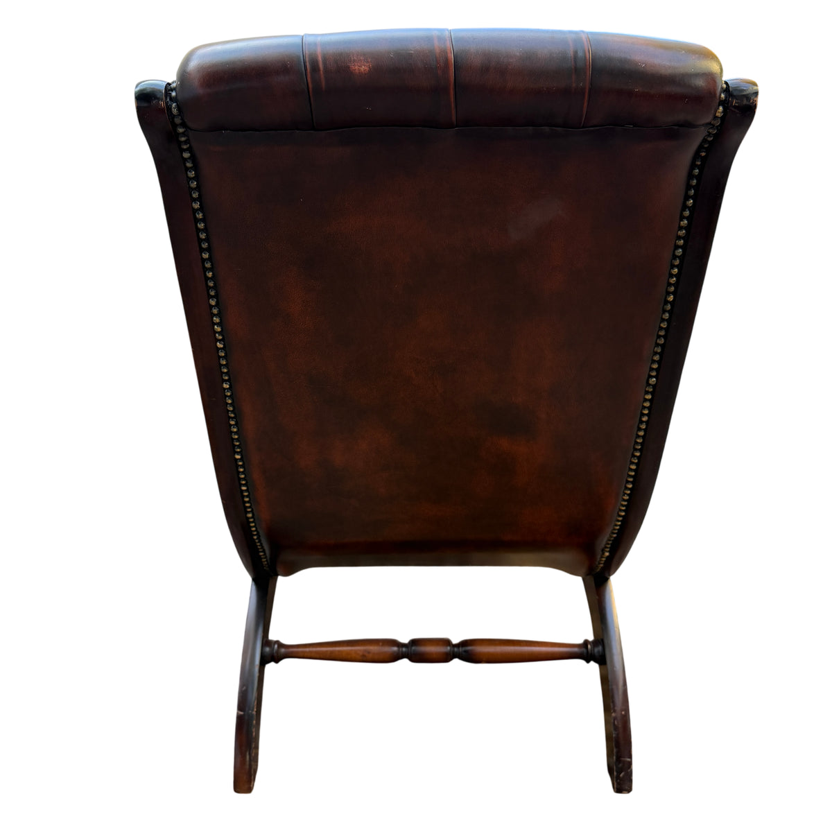 View of leather seat and front edge showing tufting and piping on armchair