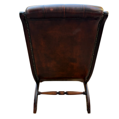 View of leather seat and front edge showing tufting and piping on armchair
