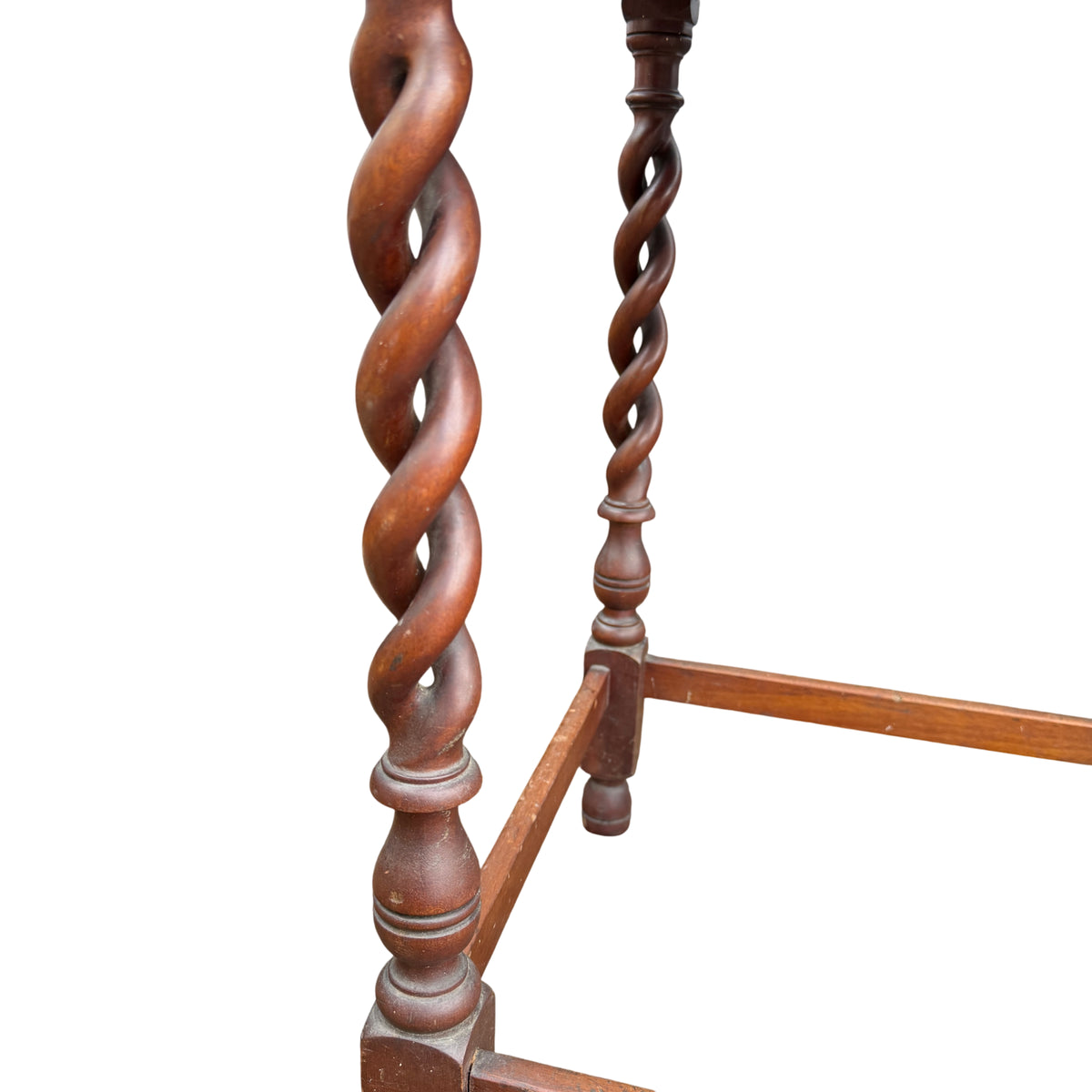 Side view of barley-twist leg and turned stretcher on vintage hall table